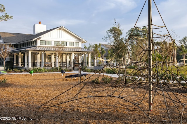 179 Charmer Trce, Saint Augustine, FL 32092 - back of house with board and batten siding, a standing seam roof, a chimney, and a metal roof