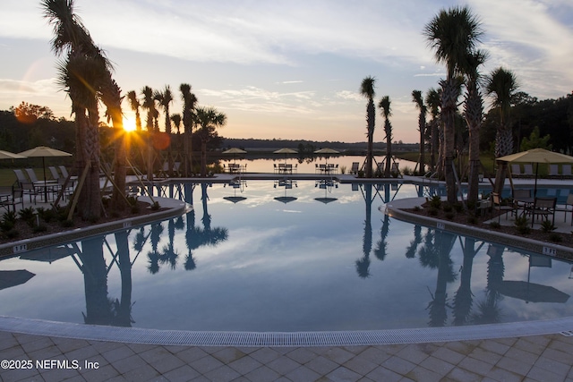 179 Charmer Trce, Saint Augustine, FL 32092 - pool at dusk featuring a community pool and a water view