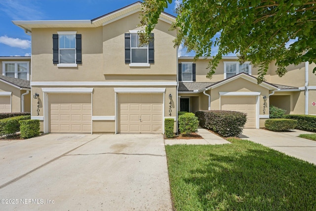 1500 Calming Water Dr Unit 4504, Fleming Island, FL 32003 - multi unit property featuring driveway, stucco siding, an attached garage, and a front yard