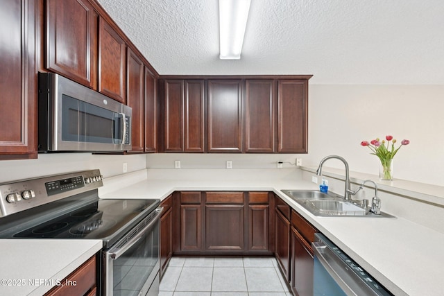 1500 Calming Water Dr Unit 4504, Fleming Island, FL 32003 - kitchen with stainless steel appliances, light tile patterned floors, light countertops, a textured ceiling, and a peninsula