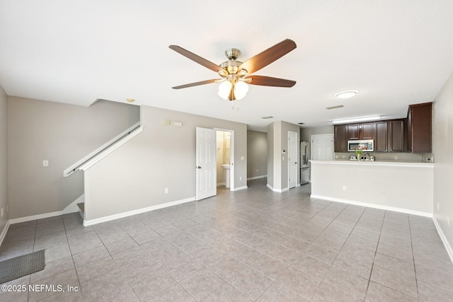 1500 Calming Water Dr Unit 4504, Fleming Island, FL 32003 - unfurnished living room featuring light tile patterned floors, a ceiling fan, and stairway