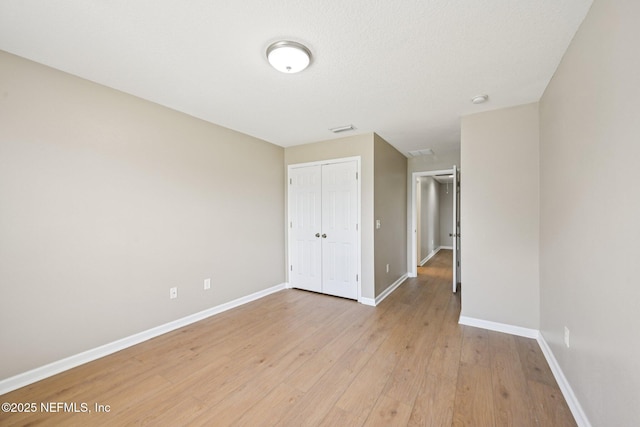 1500 Calming Water Dr Unit 4504, Fleming Island, FL 32003 - unfurnished bedroom featuring light wood-style floors and a closet