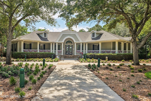1500 Calming Water Dr Unit 4504, Fleming Island, FL 32003 - view of front facade featuring covered porch, driveway, french doors, and roof with shingles