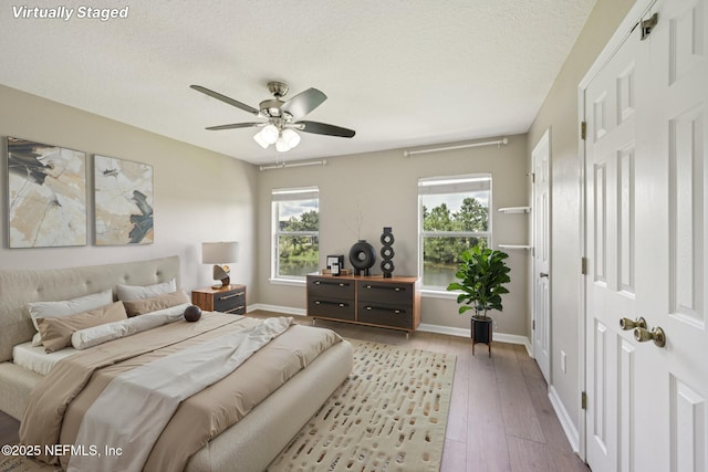 1500 Calming Water Dr Unit 4504, Fleming Island, FL 32003 - bedroom with hardwood / wood-style floors, a textured ceiling, and ceiling fan