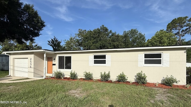 2536 Wedgefield Blvd, Jacksonville, FL 32211 - single story home with an attached garage, a front yard, concrete block siding, and driveway