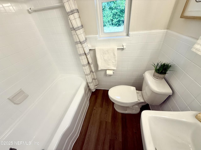 2536 Wedgefield Blvd, Jacksonville, FL 32211 - bathroom with wood finished floors, tile walls, wainscoting, and shower / tub combo