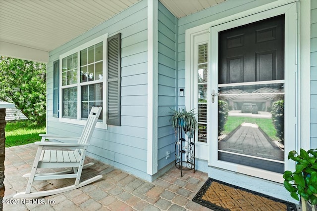 96220 Ridgewood Cir, Fernandina Beach, FL 32034 - view of exterior entry featuring covered porch