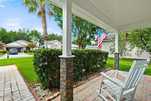 96220 Ridgewood Cir, Fernandina Beach, FL 32034 - porch with a yard, a carport, and a residential view
