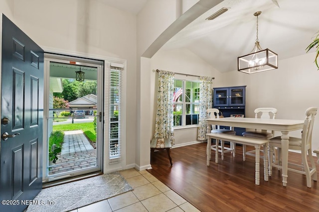96220 Ridgewood Cir, Fernandina Beach, FL 32034 - tiled entryway with healthy amount of natural light, vaulted ceiling, a chandelier, and arched walkways
