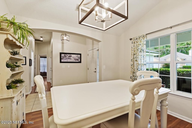 96220 Ridgewood Cir, Fernandina Beach, FL 32034 - dining room featuring wood finished floors, healthy amount of natural light, a chandelier, and lofted ceiling