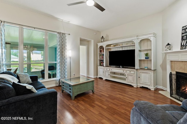 96220 Ridgewood Cir, Fernandina Beach, FL 32034 - living area featuring a ceiling fan, a tiled fireplace, and dark wood finished floors
