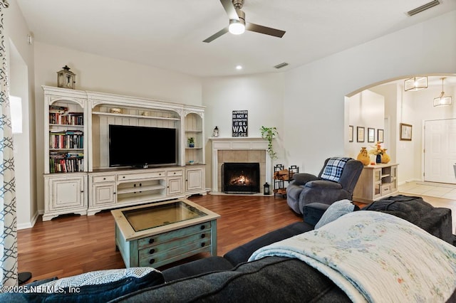 96220 Ridgewood Cir, Fernandina Beach, FL 32034 - living room with ceiling fan, arched walkways, wood finished floors, a tile fireplace, and recessed lighting