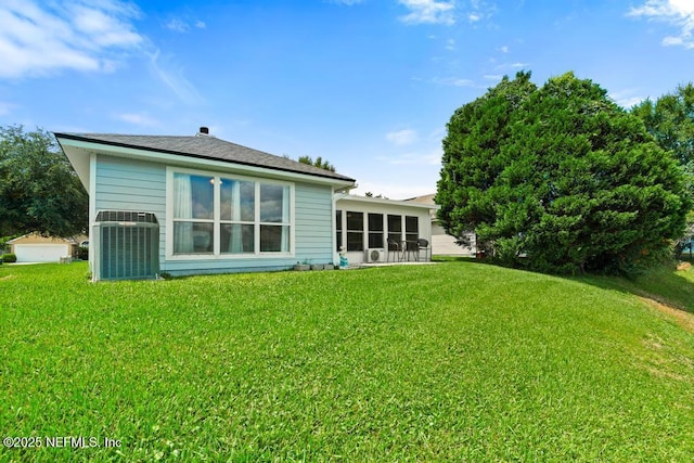 96220 Ridgewood Cir, Fernandina Beach, FL 32034 - rear view of property featuring a lawn and a sunroom