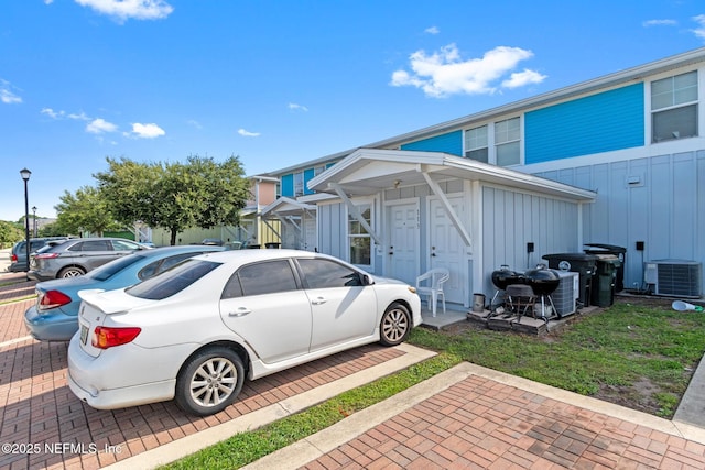 113 Oceangate Dr, Atlantic Beach, FL 32233 - view of home's exterior with board and batten siding and a cooling unit