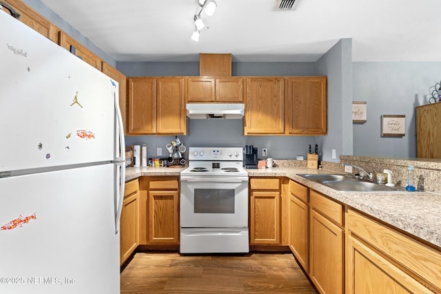 113 Oceangate Dr, Atlantic Beach, FL 32233 - kitchen featuring white appliances, under cabinet range hood, light countertops, and wood finished floors