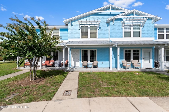 113 Oceangate Dr, Atlantic Beach, FL 32233 - view of front of property with a standing seam roof, a front yard, a porch, and a metal roof