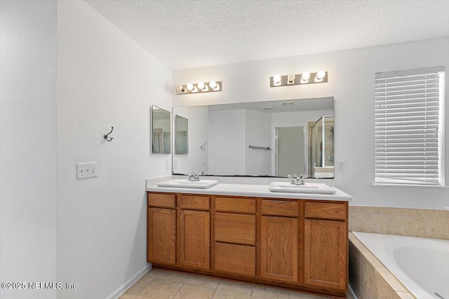 1415 Lantern Light Trl, Middleburg, FL 32068 - bathroom featuring a textured ceiling, double vanity, a bath, tile patterned flooring, and a shower with door