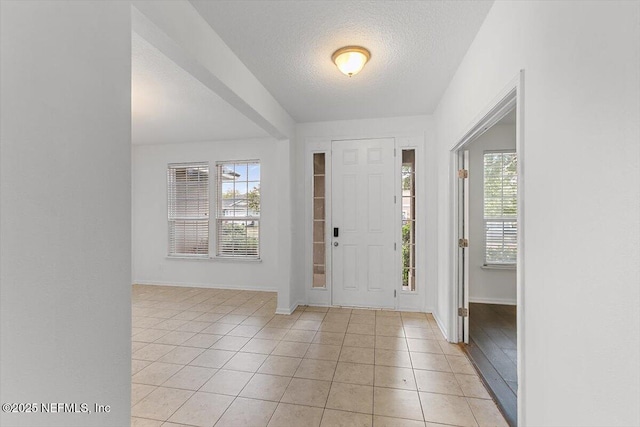 1415 Lantern Light Trl, Middleburg, FL 32068 - foyer featuring light tile patterned floors and a textured ceiling