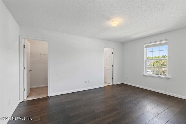 1415 Lantern Light Trl, Middleburg, FL 32068 - empty room featuring dark wood-style floors and a textured ceiling