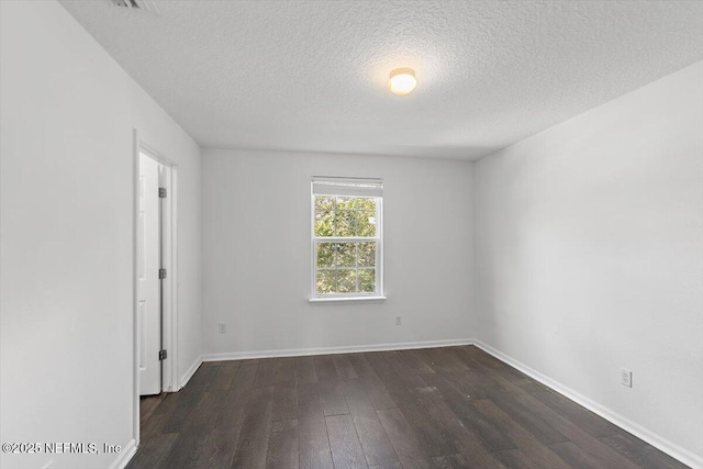1415 Lantern Light Trl, Middleburg, FL 32068 - spare room featuring dark wood-type flooring and a textured ceiling
