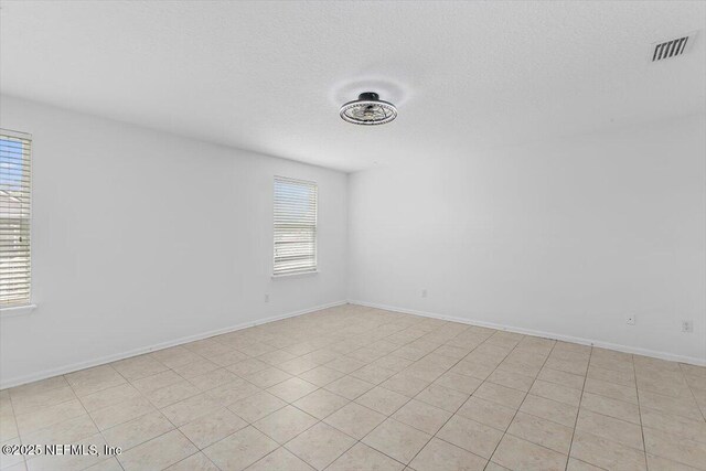 1415 Lantern Light Trl, Middleburg, FL 32068 - empty room with a textured ceiling and baseboards