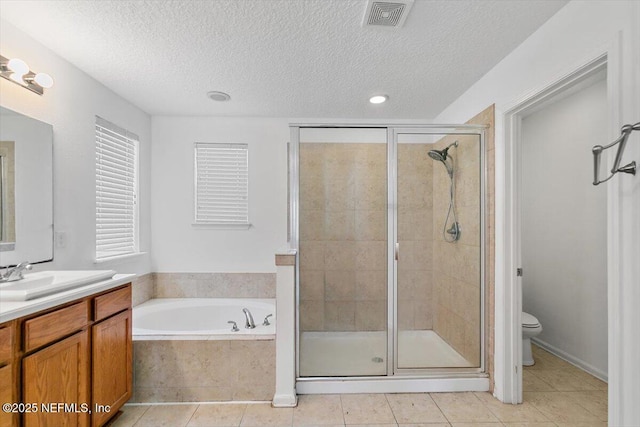 1415 Lantern Light Trl, Middleburg, FL 32068 - bathroom with vanity, a textured ceiling, a shower stall, a bath, and tile patterned floors