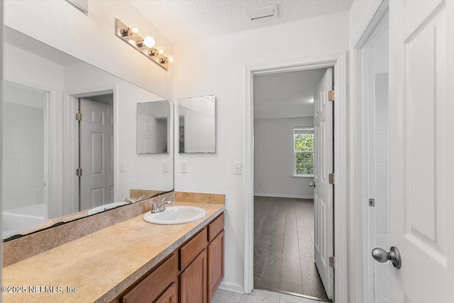 1415 Lantern Light Trl, Middleburg, FL 32068 - full bathroom featuring vanity, a textured ceiling, and wood finished floors
