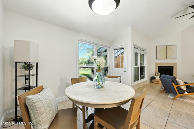736 Tidewater Ct, Ponte Vedra Beach, FL 32082 - dining area with vaulted ceiling, light tile patterned floors, a fireplace, and a ceiling fan