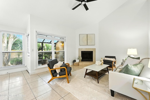 736 Tidewater Ct, Ponte Vedra Beach, FL 32082 - living area featuring light tile patterned floors, ceiling fan, a tile fireplace, and high vaulted ceiling