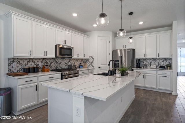 816 Blind Oak Way, Middleburg, FL 32068 - kitchen featuring appliances with stainless steel finishes, dark wood finished floors, white cabinetry, tasteful backsplash, and recessed lighting