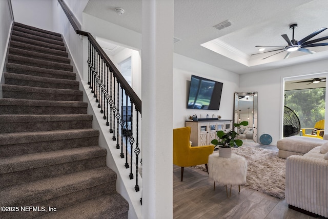 816 Blind Oak Way, Middleburg, FL 32068 - living room with ceiling fan, wood finished floors, stairs, a raised ceiling, and crown molding