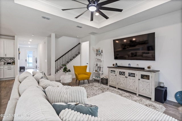 816 Blind Oak Way, Middleburg, FL 32068 - living room with a tray ceiling, ceiling fan, wood finished floors, stairs, and crown molding