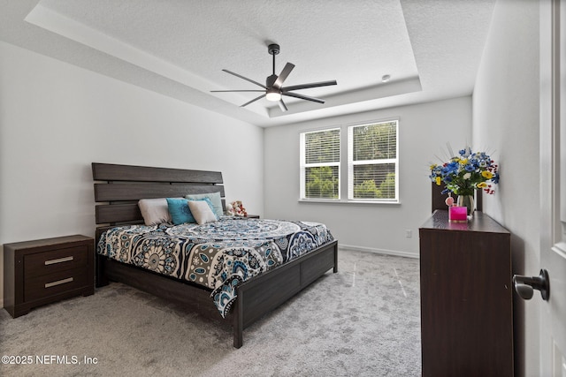 816 Blind Oak Way, Middleburg, FL 32068 - bedroom with carpet floors, a textured ceiling, a tray ceiling, and a ceiling fan
