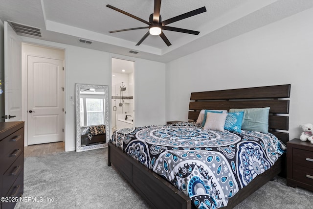 816 Blind Oak Way, Middleburg, FL 32068 - bedroom featuring a tray ceiling, carpet flooring, a ceiling fan, and ensuite bathroom
