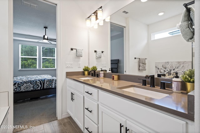 816 Blind Oak Way, Middleburg, FL 32068 - full bath featuring double vanity, connected bathroom, wood finished floors, and a ceiling fan