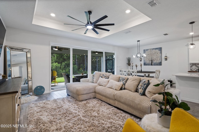 816 Blind Oak Way, Middleburg, FL 32068 - living room with a ceiling fan, wood finished floors, a tray ceiling, recessed lighting, and crown molding