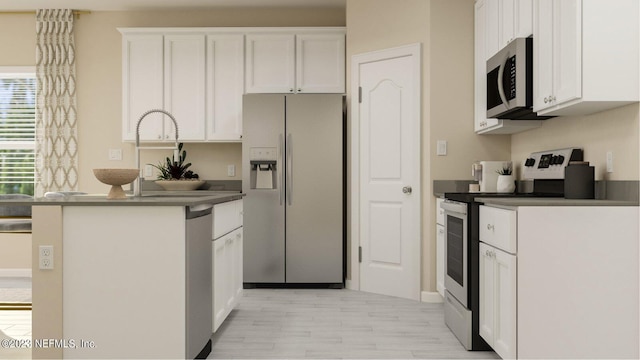 100 Round Robin Run, Saint Johns, FL 32259 - kitchen with appliances with stainless steel finishes, dark countertops, white cabinets, light wood-style flooring, and a peninsula