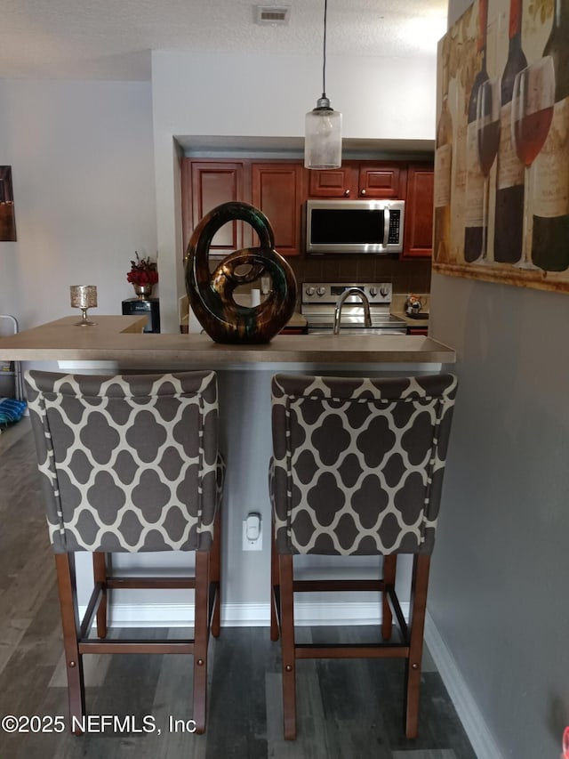 3671 Kirkpatrick Cir Unit 6, Jacksonville, FL 32210 - bar featuring stainless steel appliances and pendant lighting