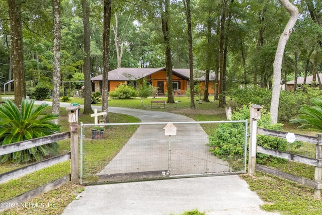 4253 Chokeberry Rd, Middleburg, FL 32068 - view of front facade with a gate, a fenced front yard, and driveway