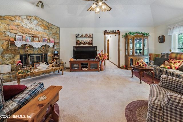 4253 Chokeberry Rd, Middleburg, FL 32068 - living area featuring vaulted ceiling, a ceiling fan, carpet floors, and a fireplace