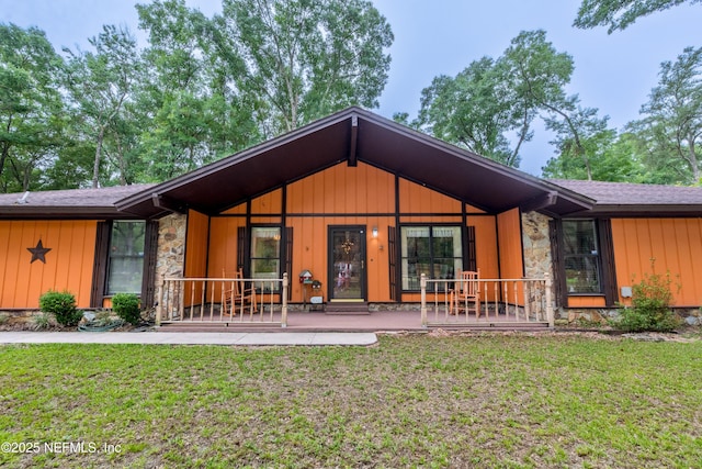 4253 Chokeberry Rd, Middleburg, FL 32068 - back of property featuring stone siding, a lawn, and board and batten siding