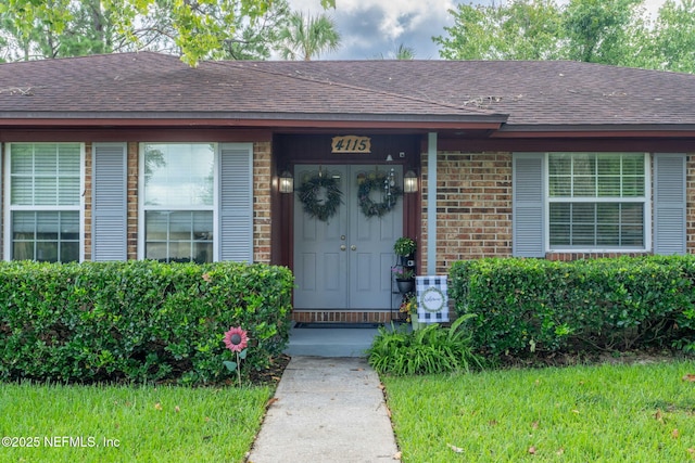 4115 Wilcrest Cir W, Jacksonville, FL 32277 - doorway to property featuring a shingled roof and brick siding