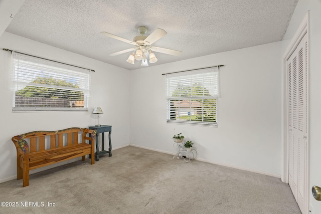 4115 Wilcrest Cir W, Jacksonville, FL 32277 - carpeted bedroom with multiple windows, a closet, a textured ceiling, and ceiling fan