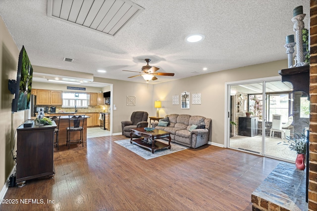 4115 Wilcrest Cir W, Jacksonville, FL 32277 - living room with a textured ceiling, ceiling fan, plenty of natural light, wood finished floors, and recessed lighting