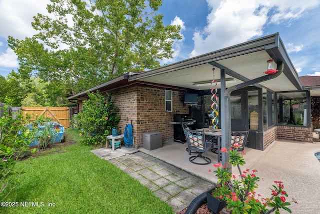 4115 Wilcrest Cir W, Jacksonville, FL 32277 - rear view of property with a patio area and brick siding