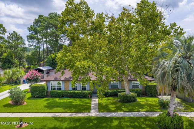 4115 Wilcrest Cir W, Jacksonville, FL 32277 - obstructed view of property with a front yard and brick siding