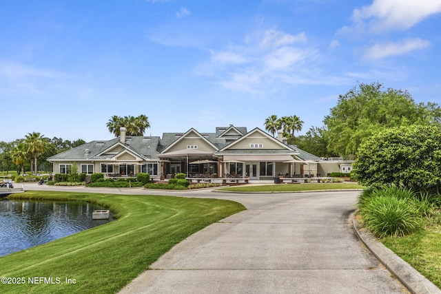 1506 Waterbridge Ct, Fleming Island, FL 32003 - view of front of home with a front lawn, a water view, and a porch