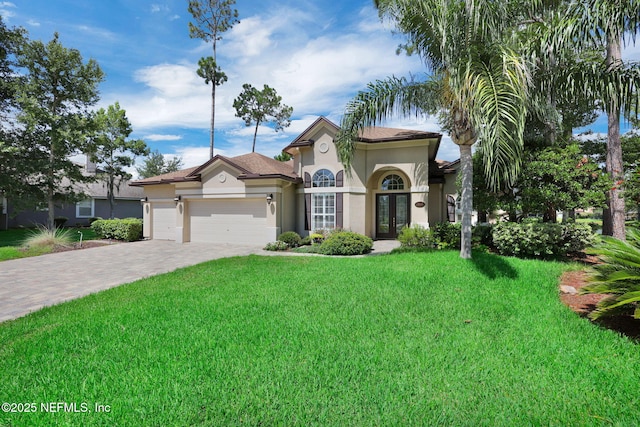 1506 Waterbridge Ct, Fleming Island, FL 32003 - mediterranean / spanish home featuring french doors, stucco siding, decorative driveway, and a front yard