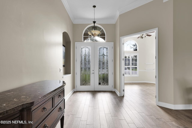 1506 Waterbridge Ct, Fleming Island, FL 32003 - foyer entrance featuring french doors, arched walkways, crown molding, and wood finished floors