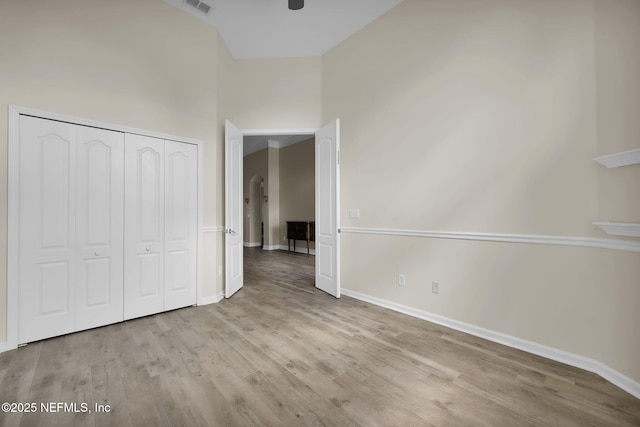 1506 Waterbridge Ct, Fleming Island, FL 32003 - unfurnished bedroom with wood finished floors, a closet, and a high ceiling